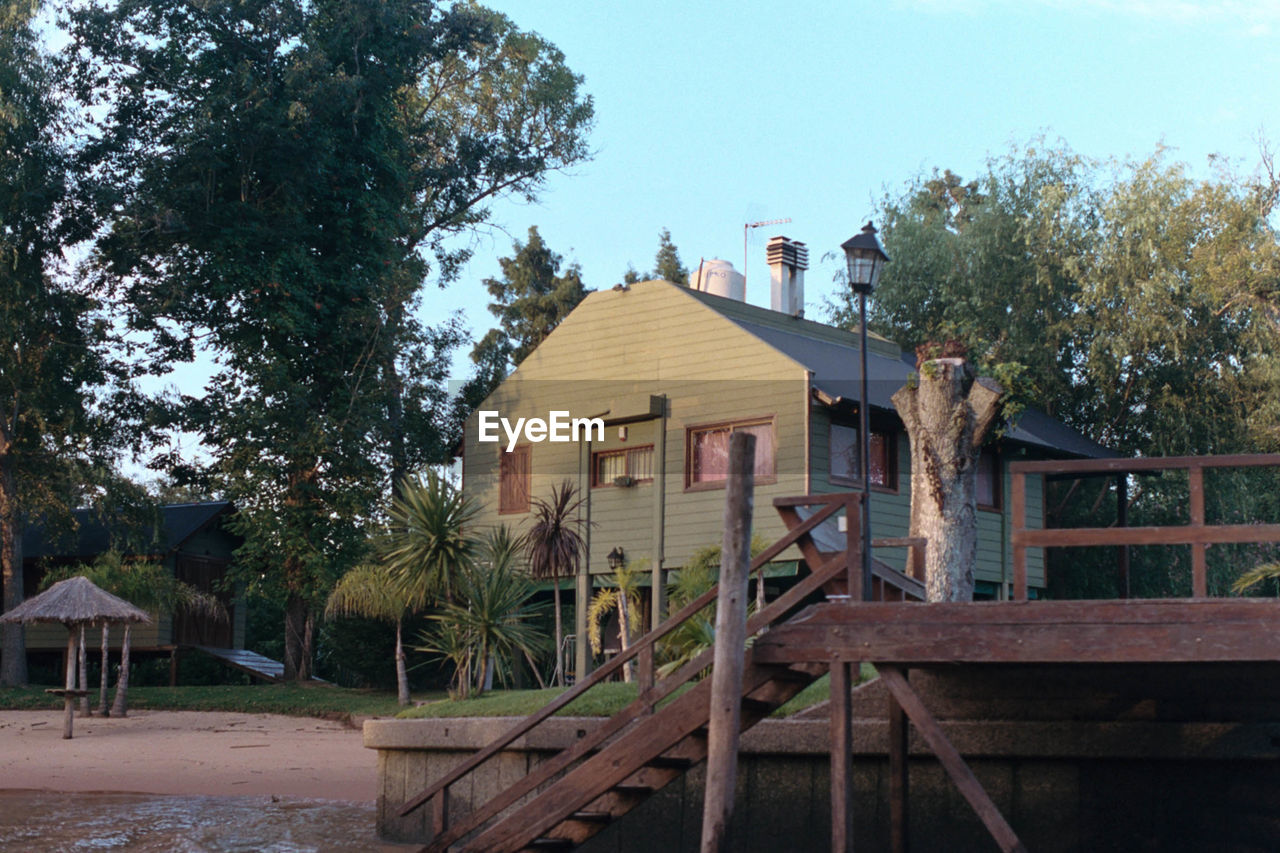 HOUSES AND TREES BY BUILDING AGAINST SKY