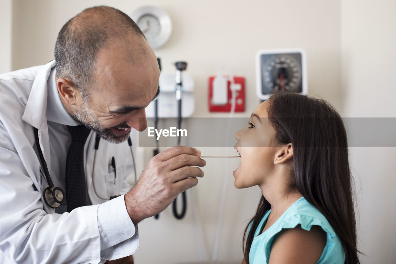 Doctor checking girl in medical examination room