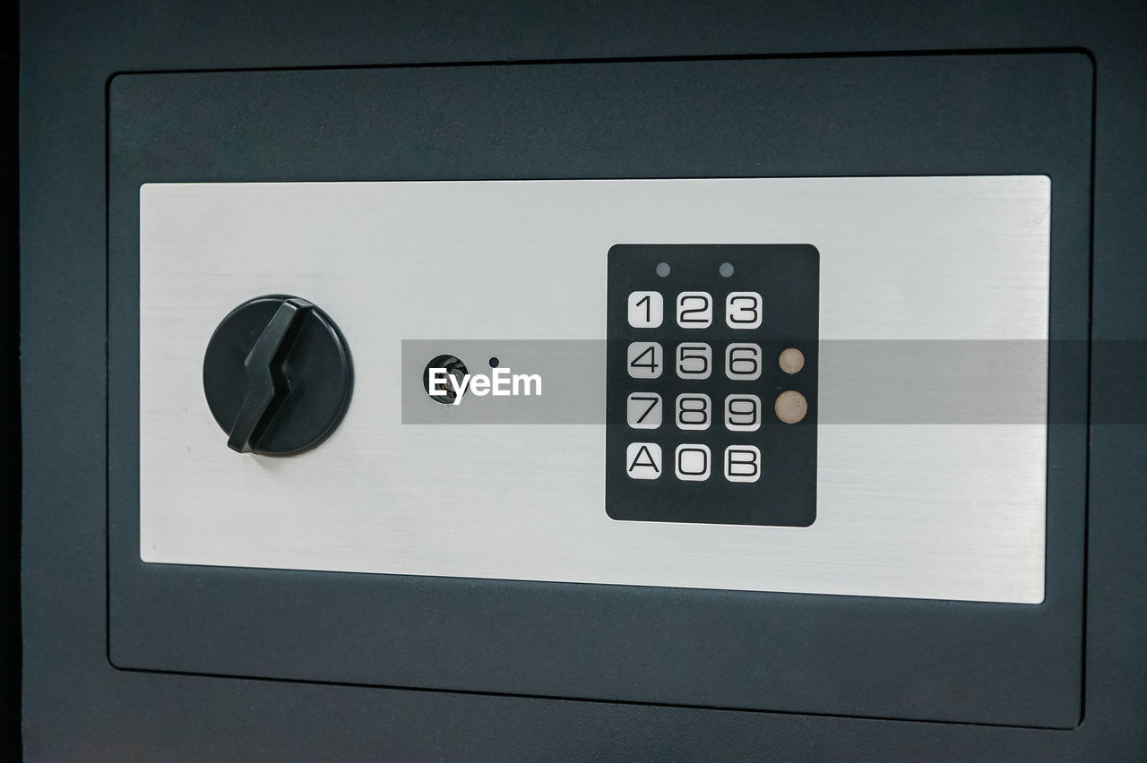 A black safe with a combination lock. deposit module for storing money at home and in the office