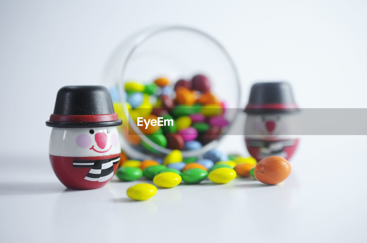 Close-up of multi colored candies in glass on table