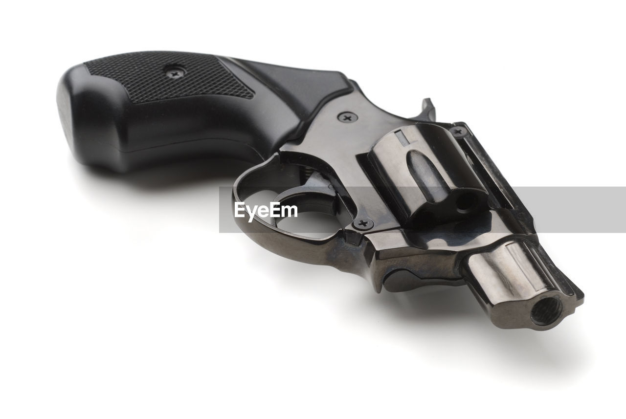 Close-up of handgun over white background