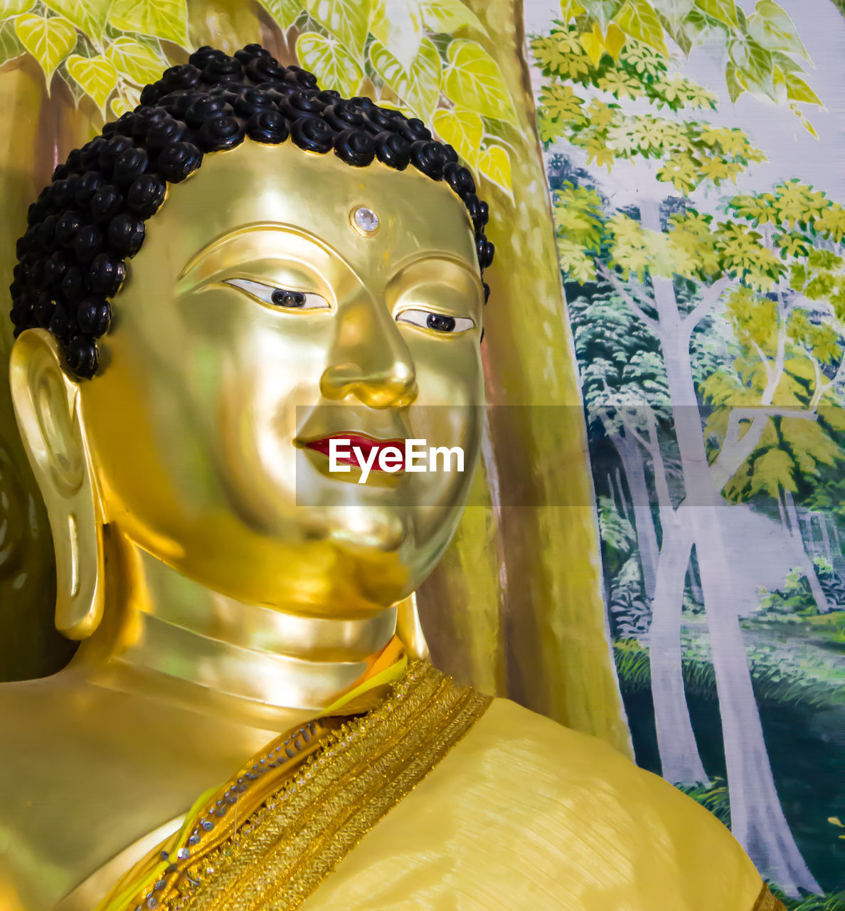 Close-up of buddha statue against building