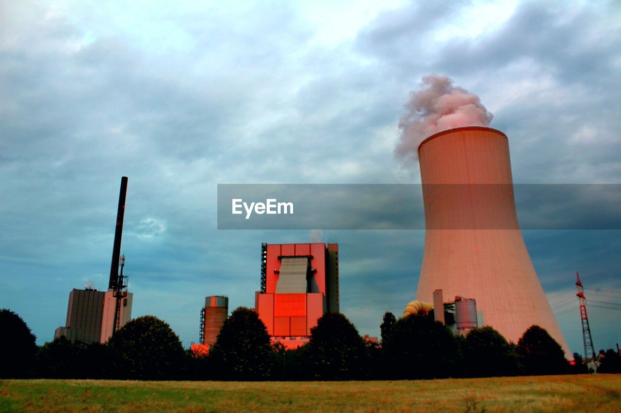 LOW ANGLE VIEW OF SMOKE STACK BY FACTORY AGAINST SKY