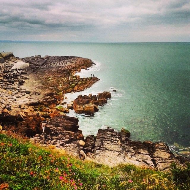 SCENIC VIEW OF SEA WITH ROCKS IN BACKGROUND