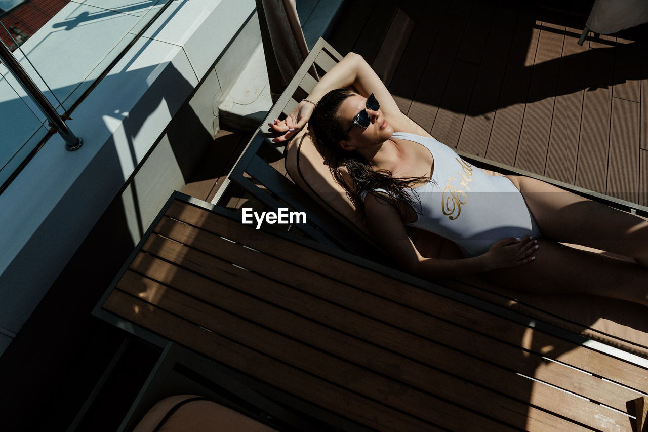 High angle view of woman sitting at the pool