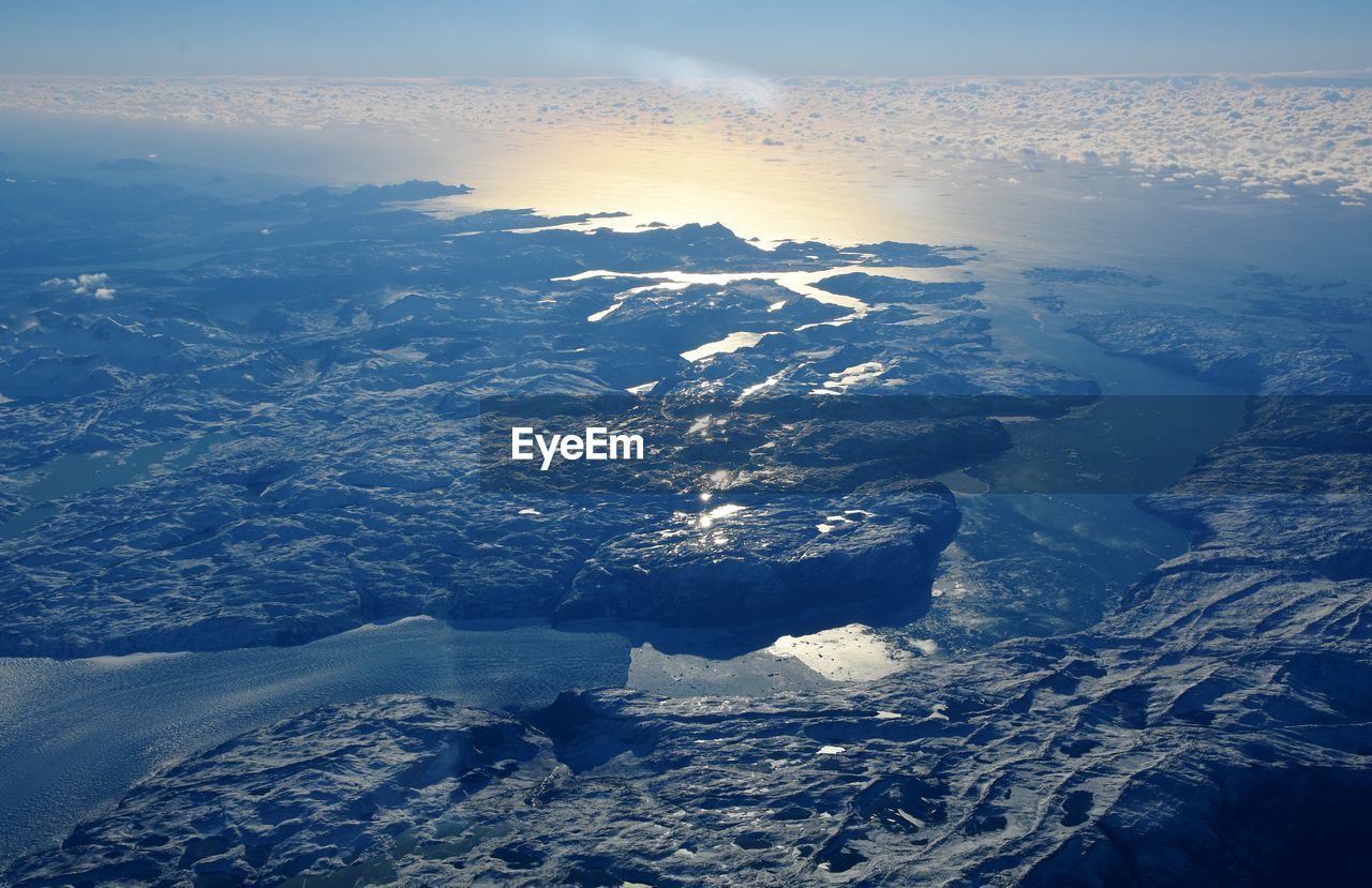 Aerial view of frozen landscape against sky during winter