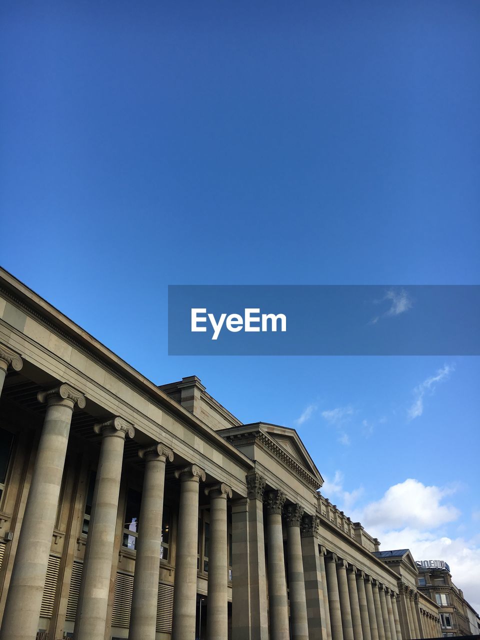 Low angle view of government building against blue sky