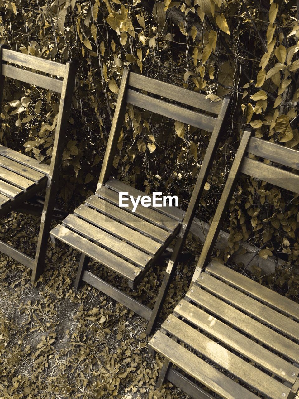 Close-up high angle view of empty wooden chairs