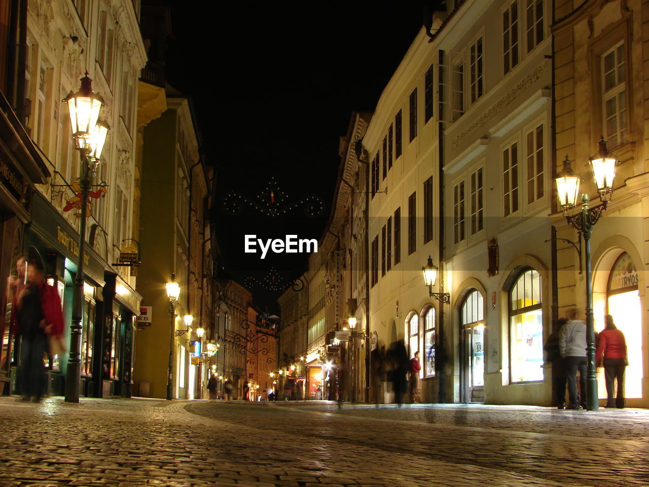 ILLUMINATED STREET AT NIGHT IN CITY AT DUSK