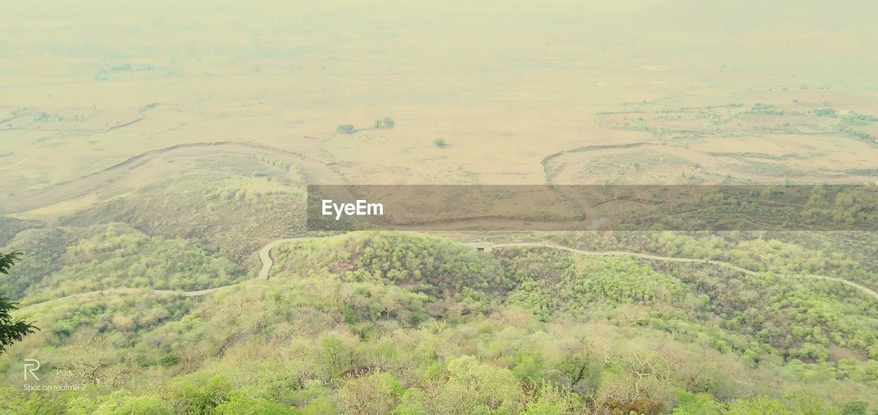 HIGH ANGLE VIEW OF LAND ON SHORE AGAINST SKY