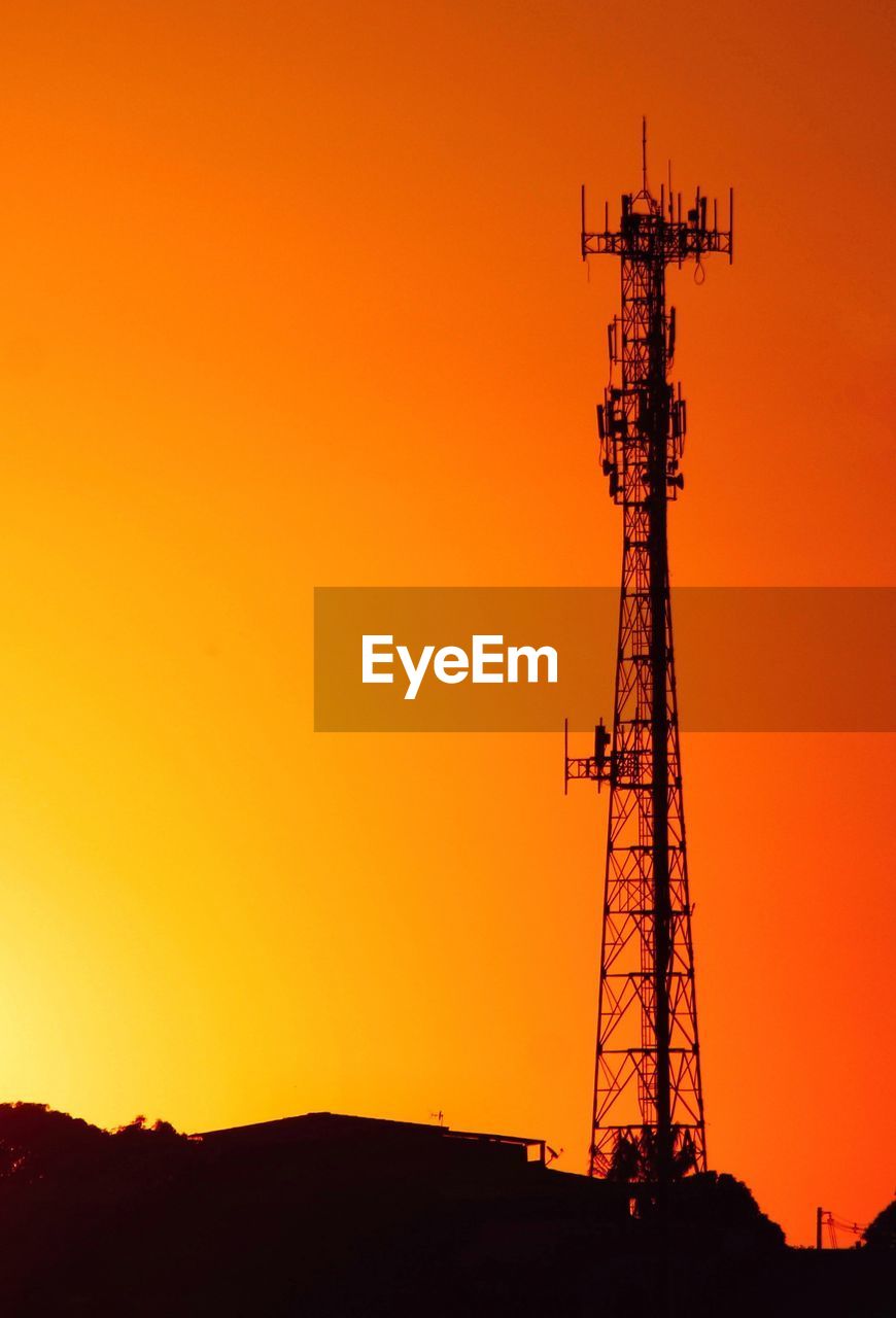 SILHOUETTE OF COMMUNICATIONS TOWER DURING SUNSET