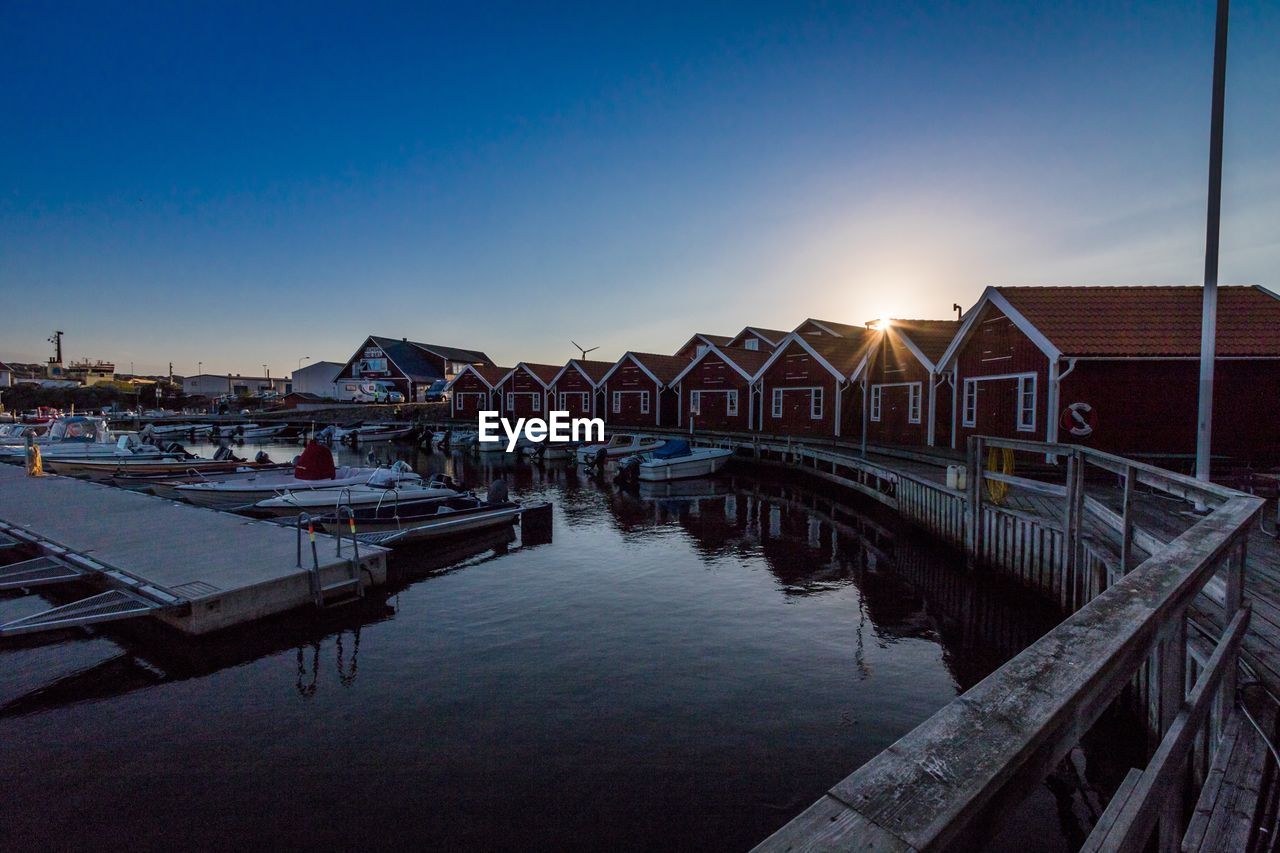 View of pier at harbor during sunset