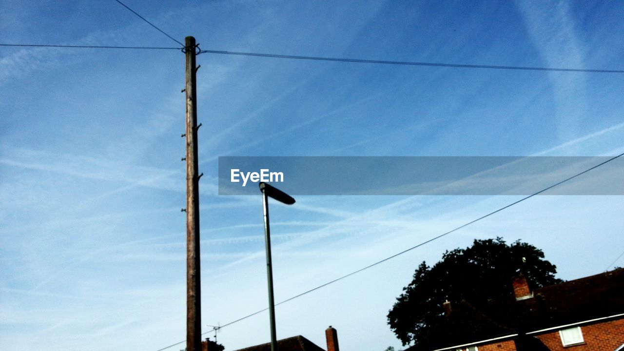 Low angle view of telephone pole against sky