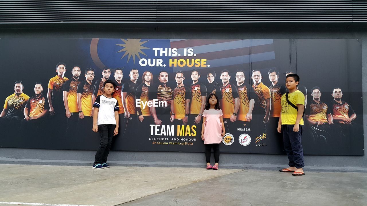 PEOPLE STANDING ON A ROAD WITH TEXT