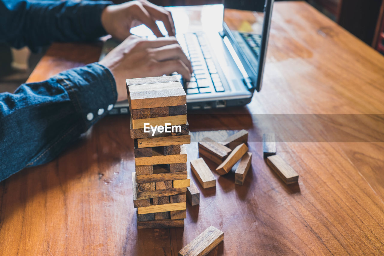 High angle view of man sitting on wooden table