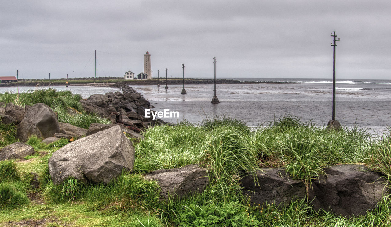 SCENIC VIEW OF SEA AND ROCKS AGAINST SKY