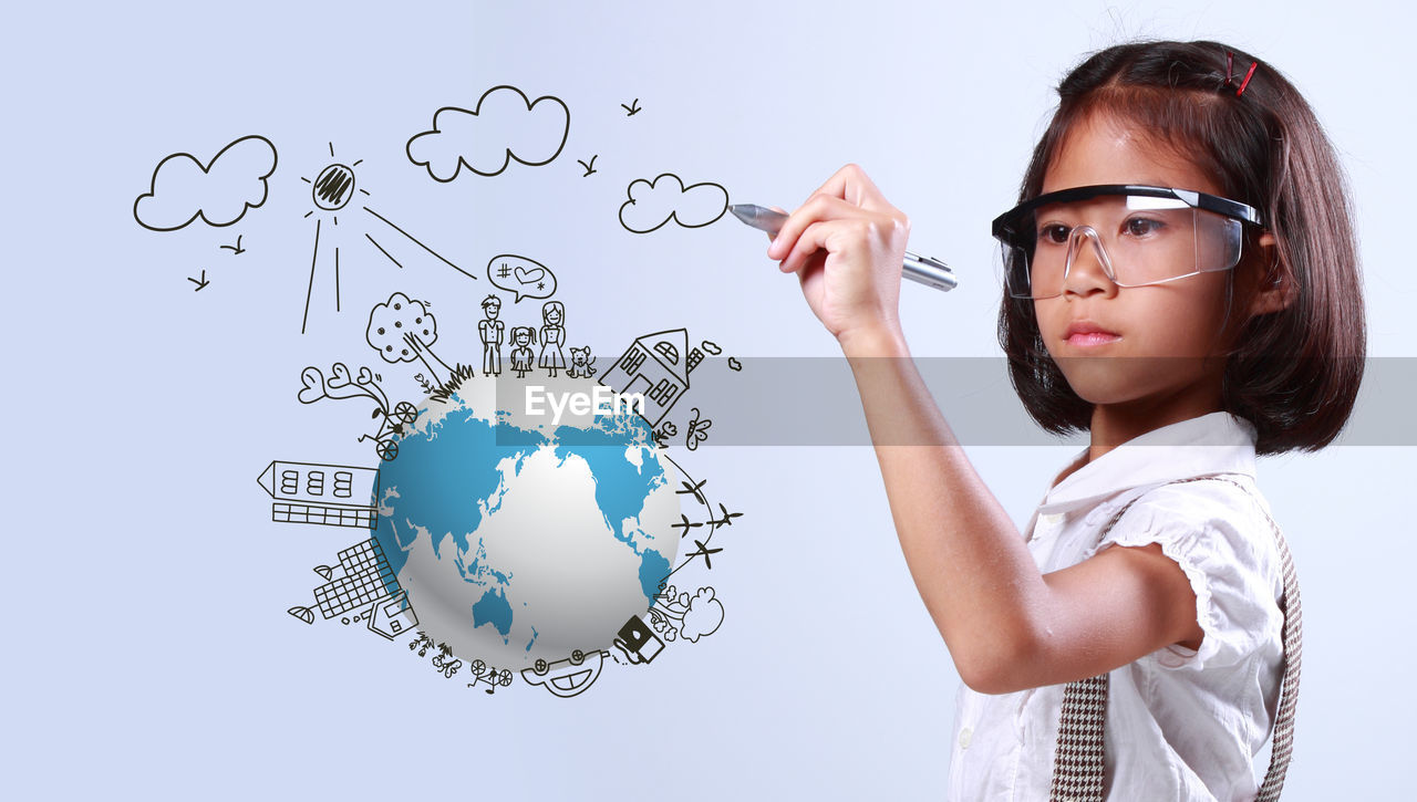 Digital composite image of girl drawing over earth against white background