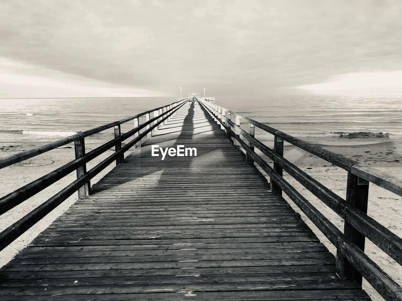 Pier over sea against sky