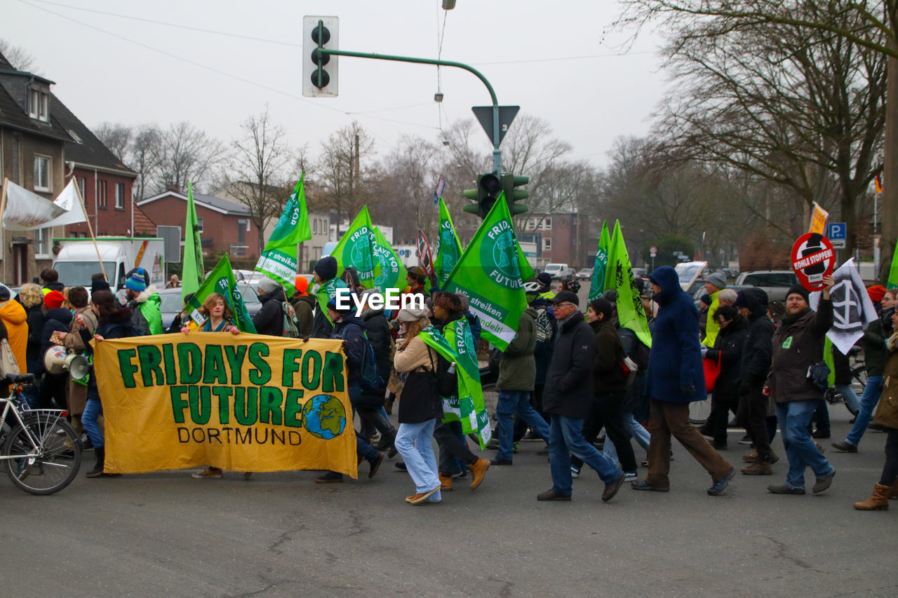 PEOPLE ON STREET AGAINST CITY