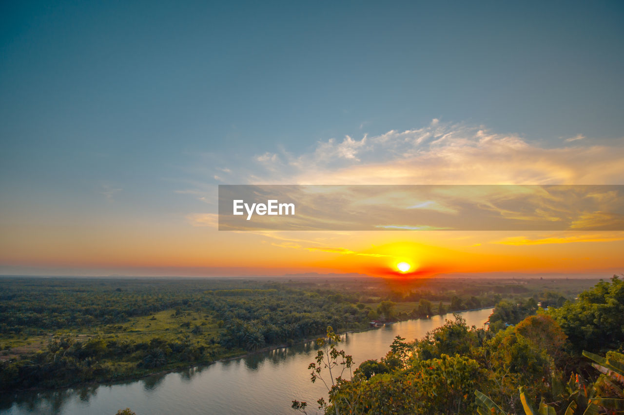 SCENIC VIEW OF LANDSCAPE AGAINST ORANGE SKY