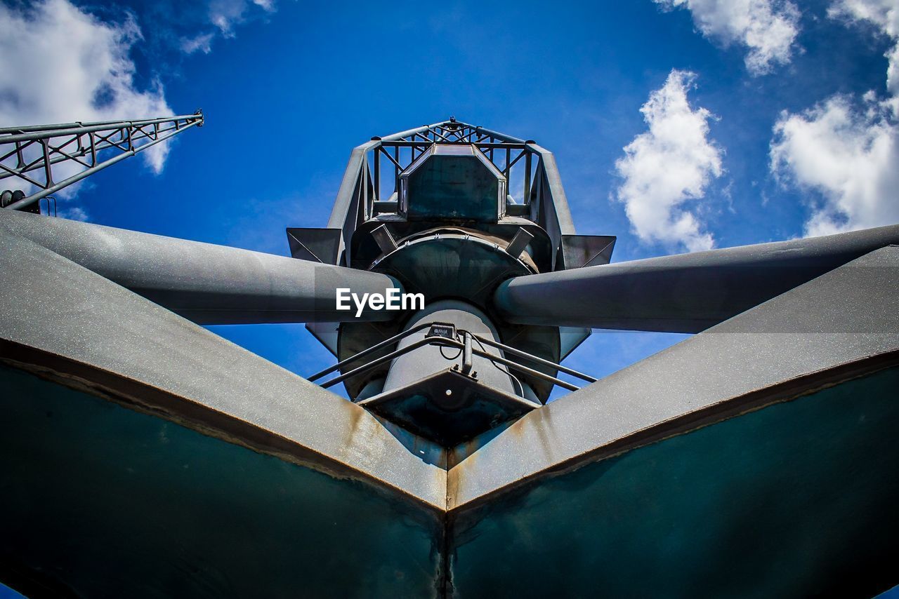 LOW ANGLE VIEW OF METALLIC STRUCTURE AGAINST SKY