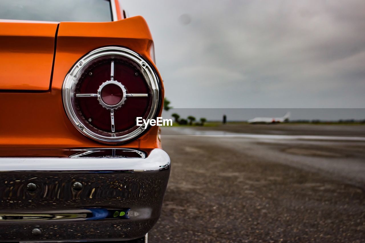 Cropped image of vintage car on road