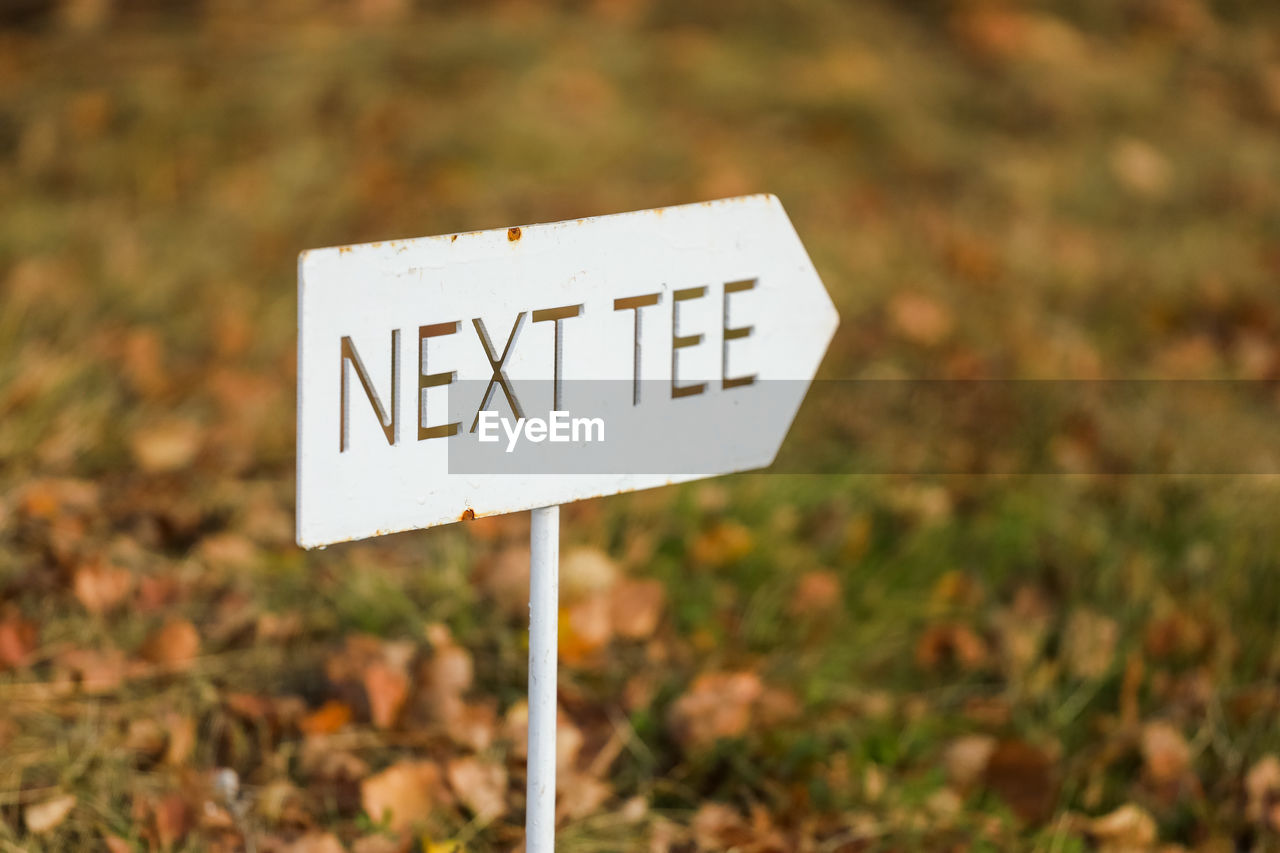 sign, communication, nature, no people, text, focus on foreground, grass, leaf, guidance, signage, outdoors, road, road sign, day, plant, warning sign, close-up, western script, land, soil, symbol, autumn, prairie