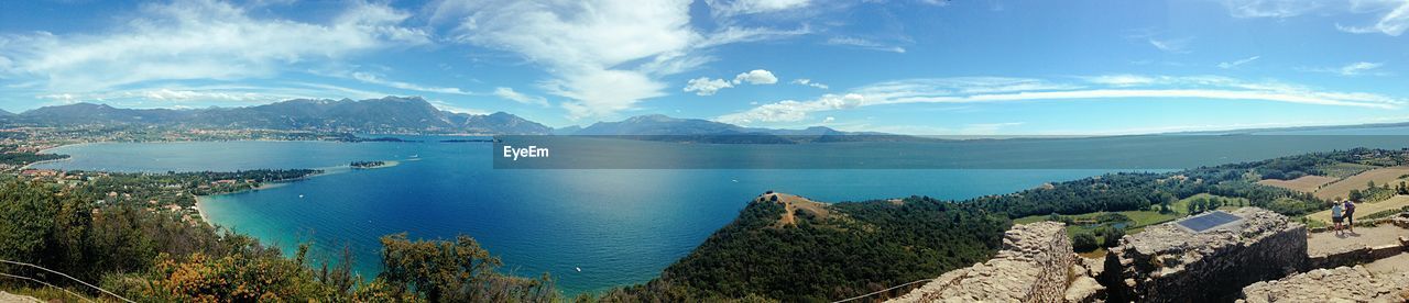 Panoramic view of sea and mountains against sky