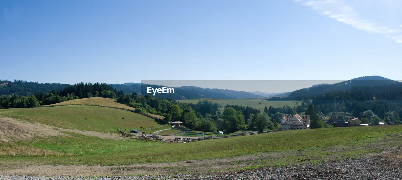 environment, landscape, sky, scenics - nature, mountain, mountain range, land, plant, beauty in nature, nature, tree, tranquility, tranquil scene, plateau, ridge, no people, rural area, valley, grass, meadow, blue, field, rural scene, non-urban scene, highland, mountain pass, green, forest, lake, travel, idyllic, wilderness, pinaceae, grassland, day, coniferous tree, cloud, outdoors, travel destinations, pine tree, building, architecture, plain, agriculture, clear sky, house, social issues, tourism, water, summer, sunlight, pine woodland