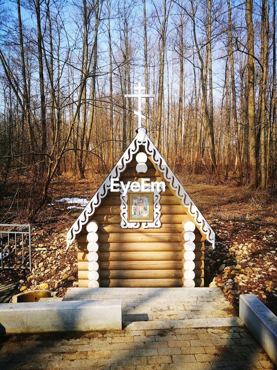 BUILT STRUCTURE BY BARE TREES AGAINST SKY