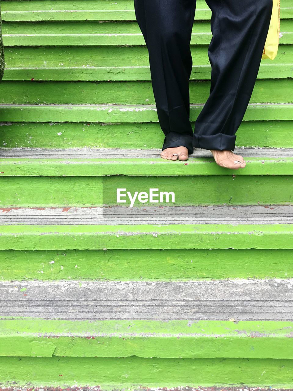 Low section of man standing on staircase