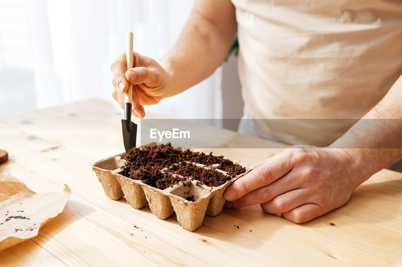 cropped hand of woman holding cake