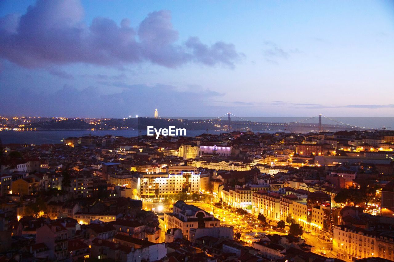 High angle view of illuminated cityscape against sky at dusk