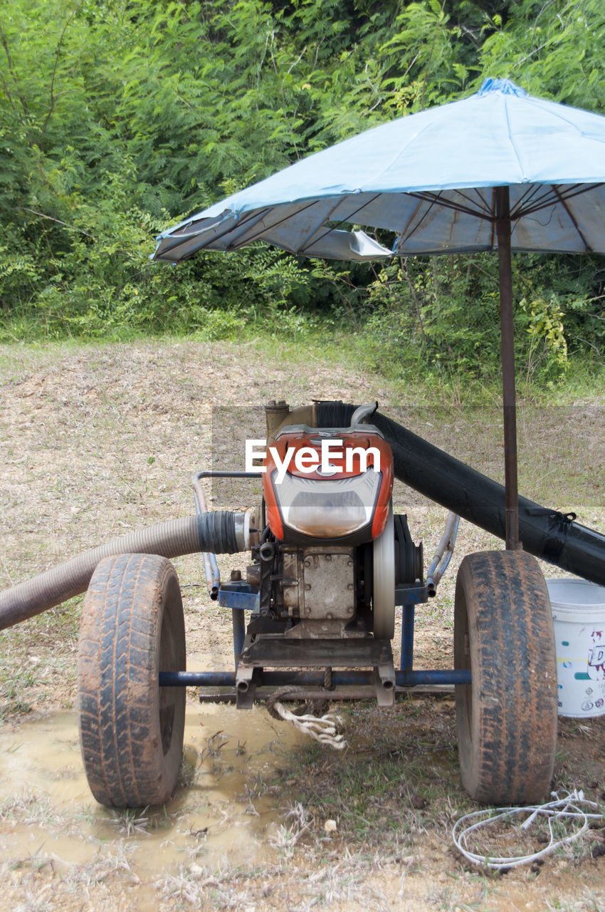 Pipes attached to tractor on field