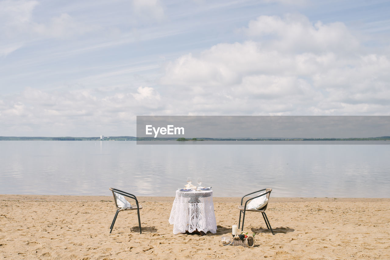 Table and chair for a romantic dinner by the sea, lake or ocean for a honeymoon