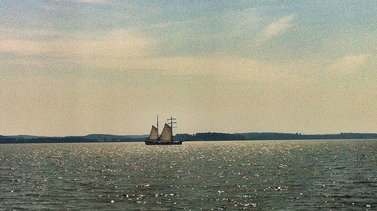 Boat sailing on sea against sky