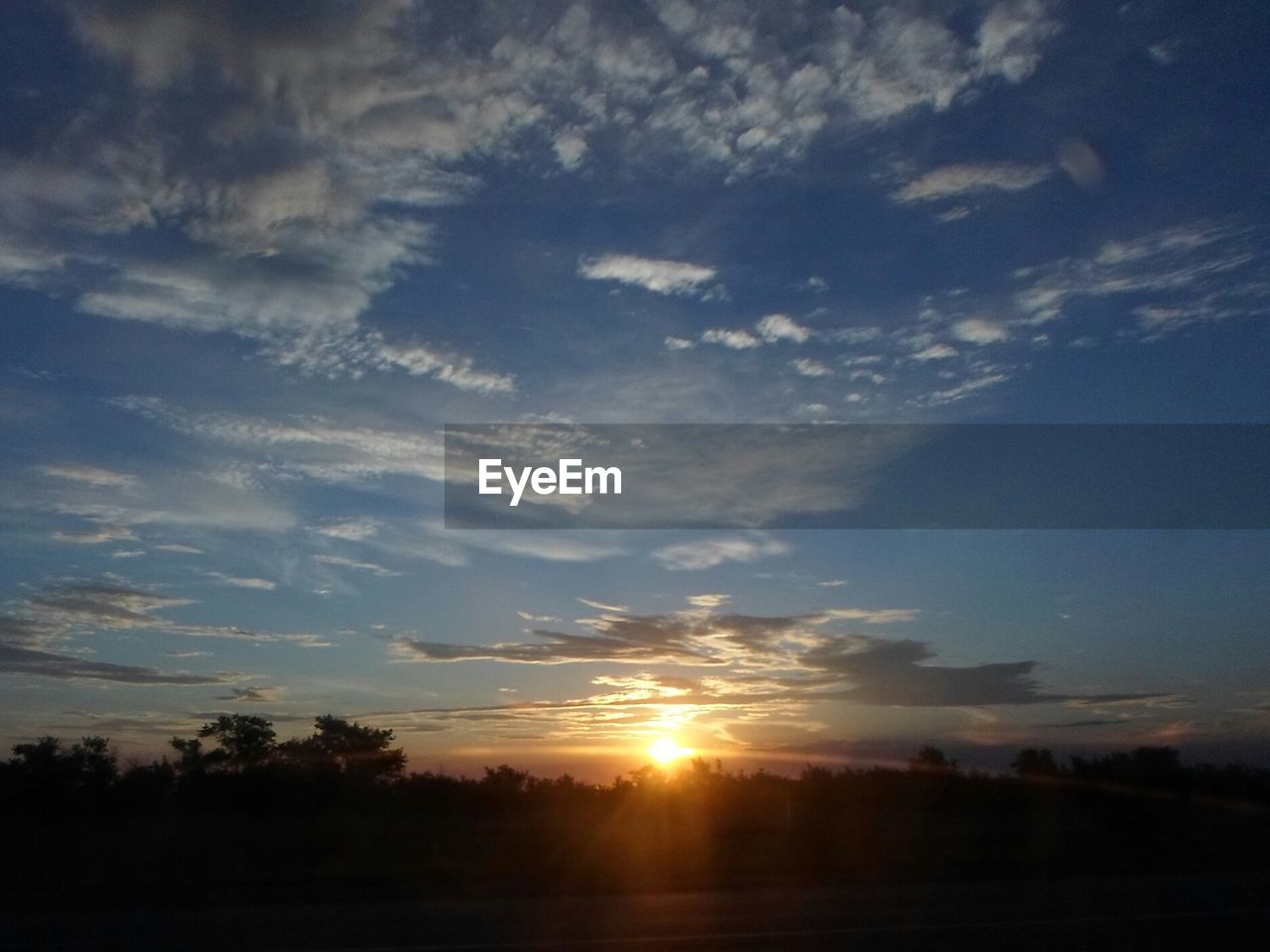 SCENIC VIEW OF SUNSET OVER LANDSCAPE