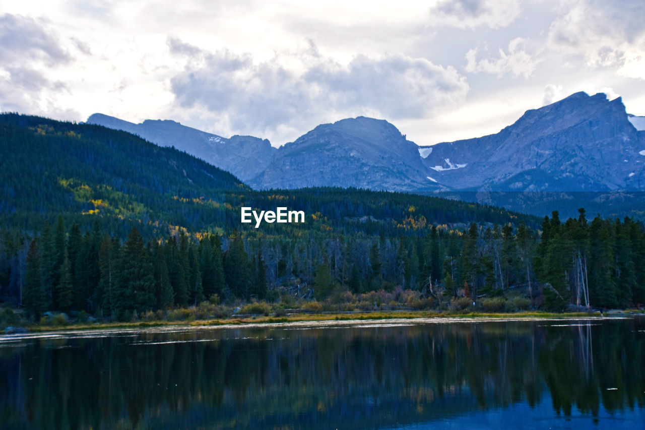 Scenic view of lake and mountains against sky