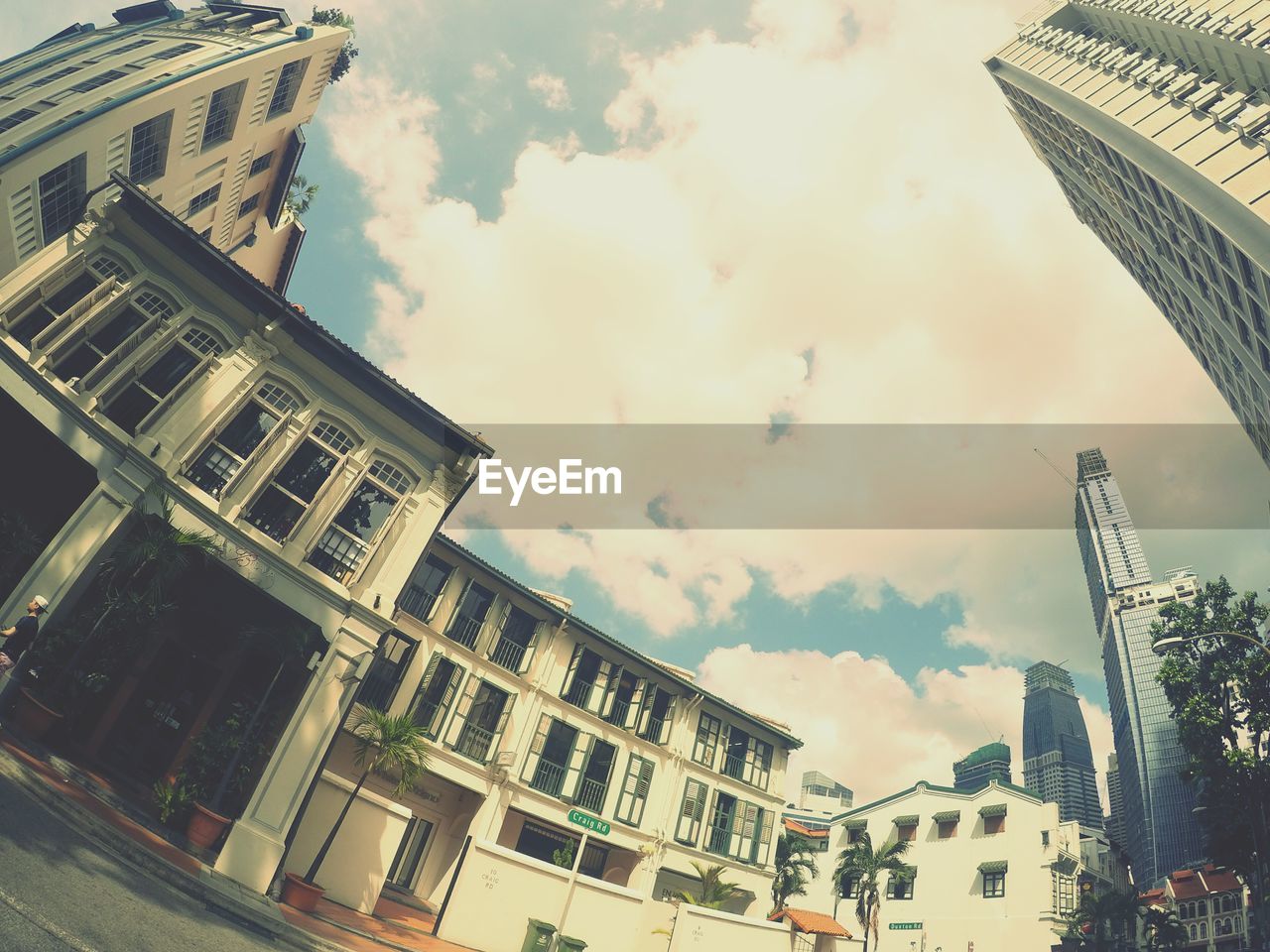 Low angle view of buildings against cloudy sky