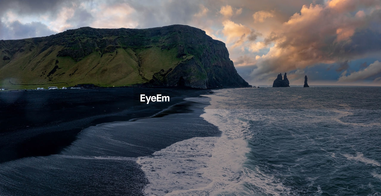 Iceland black sand beach with huge waves at reynisfjara vik.