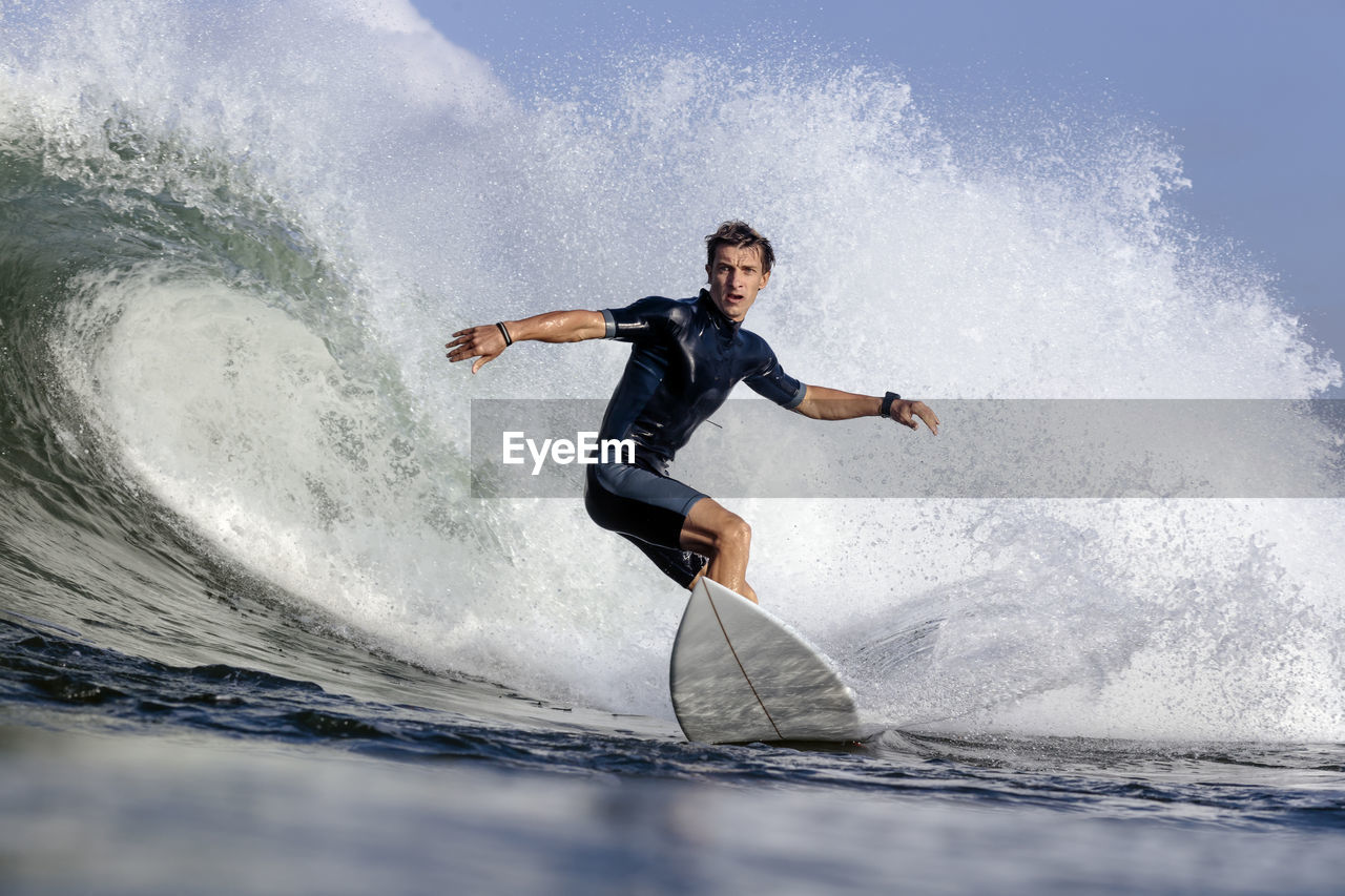 Low angle view of man surfing on sea