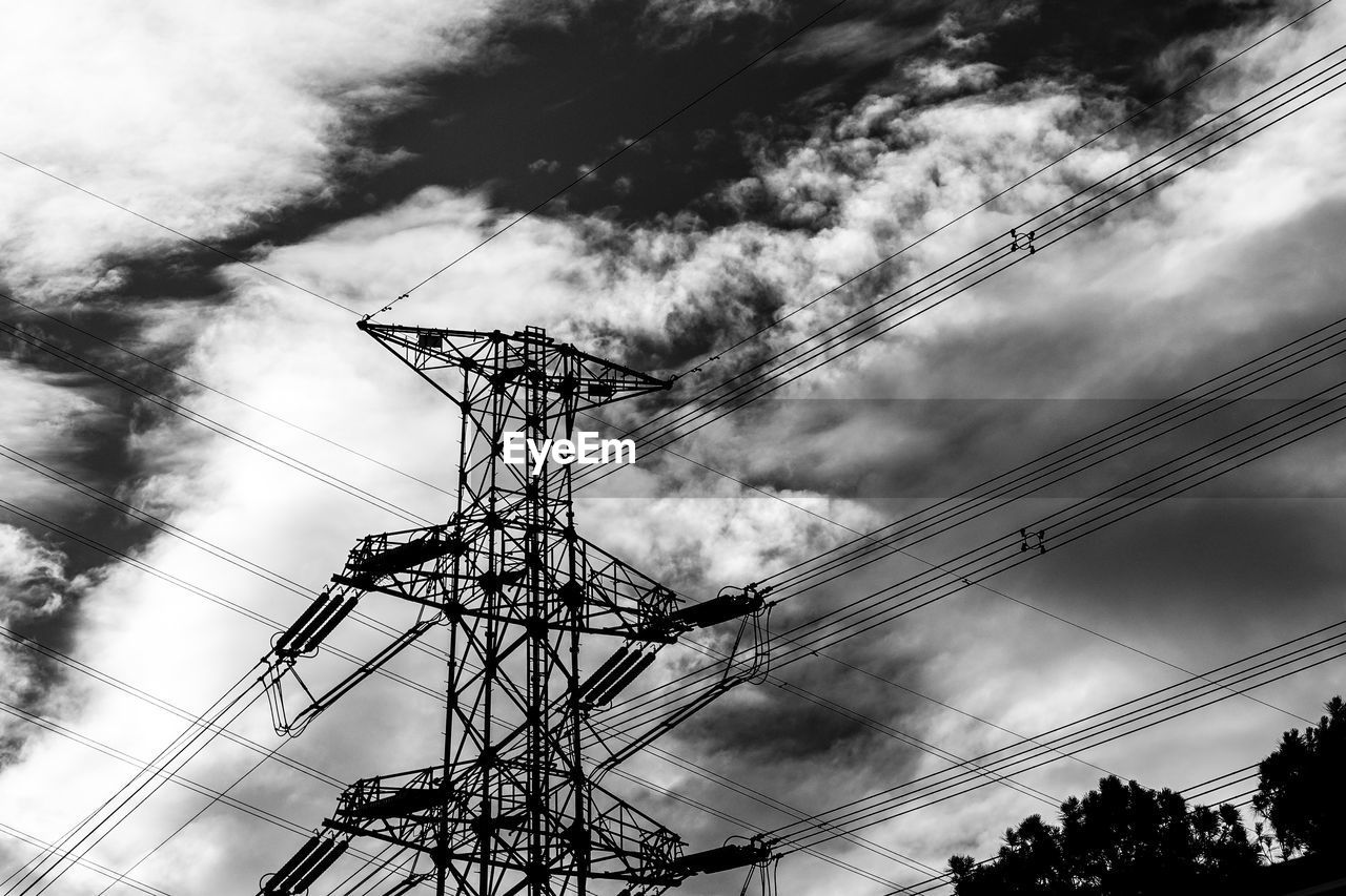 Low angle view of electricity pylon against sky