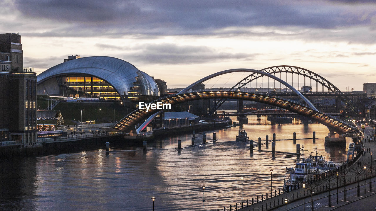 Bridge over river with city in background