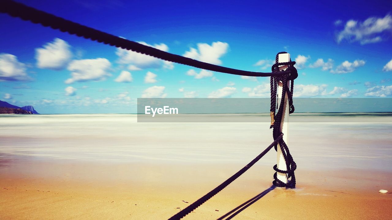 CLOSE-UP OF ROPES ON BEACH