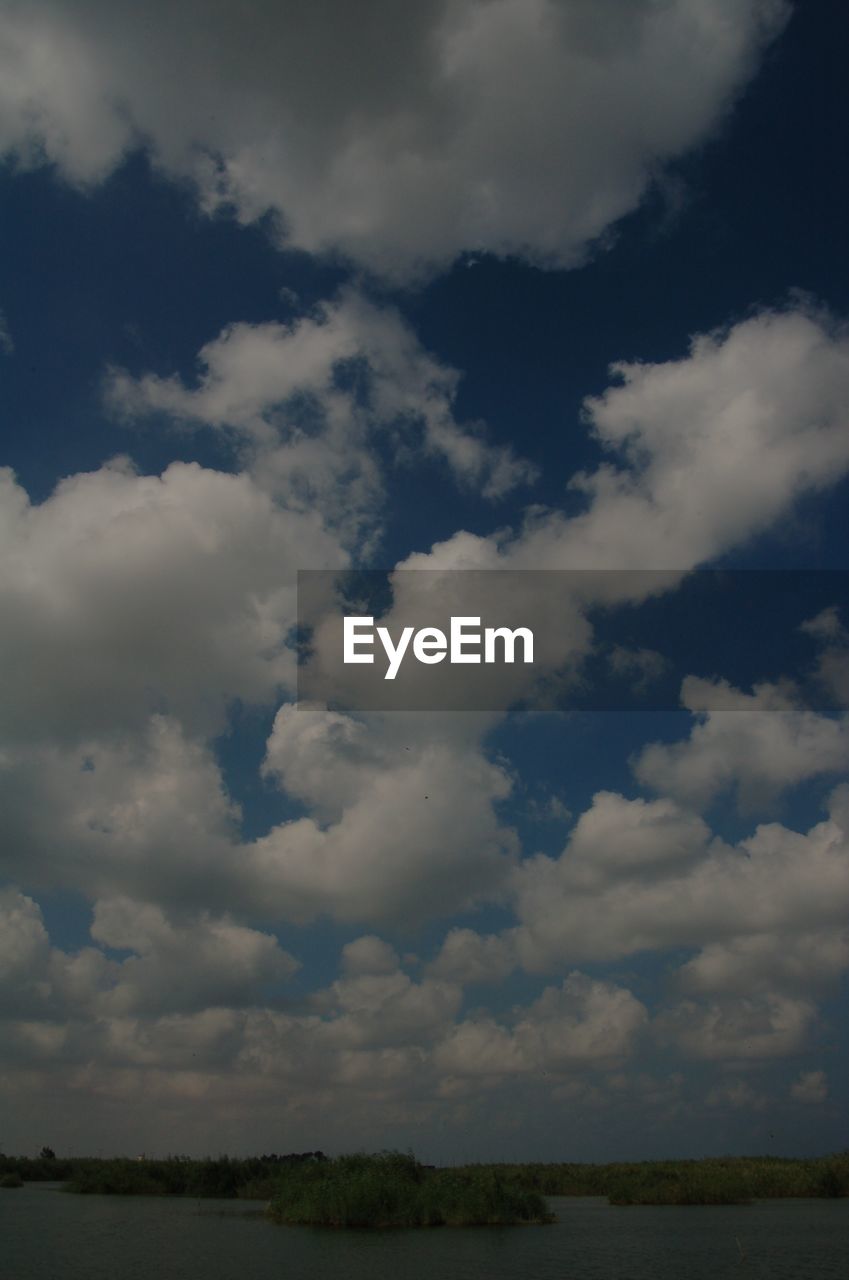 SCENIC VIEW OF CLOUDS OVER LANDSCAPE AGAINST SKY AND SUNLIGHT