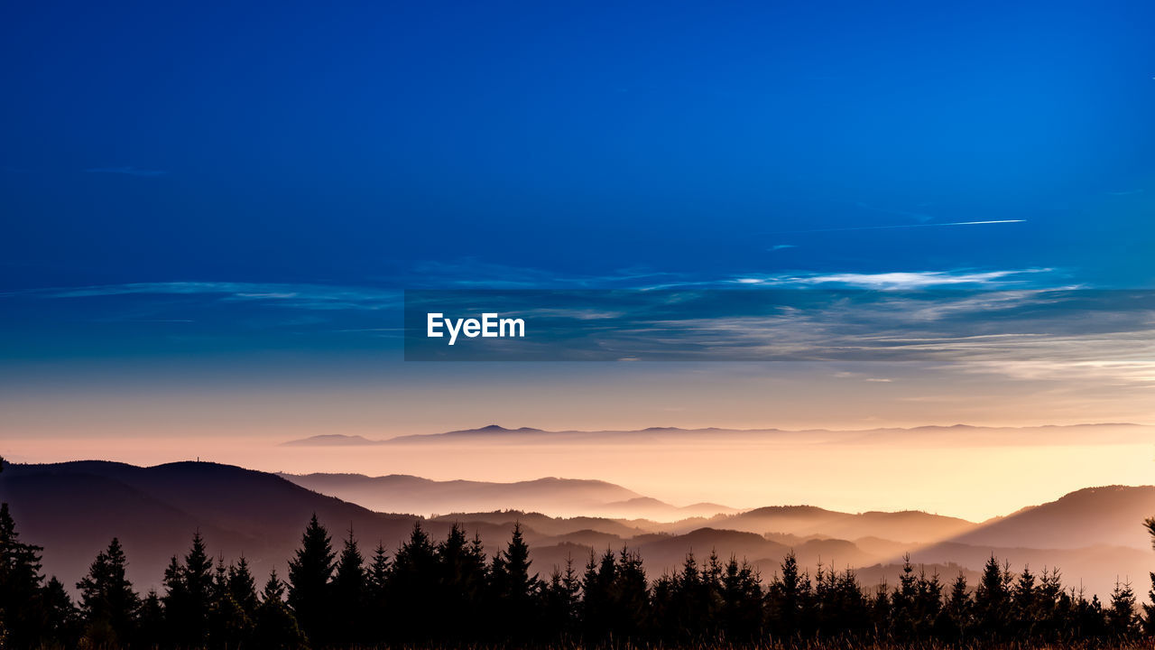 Scenic view of landscape against sky at night