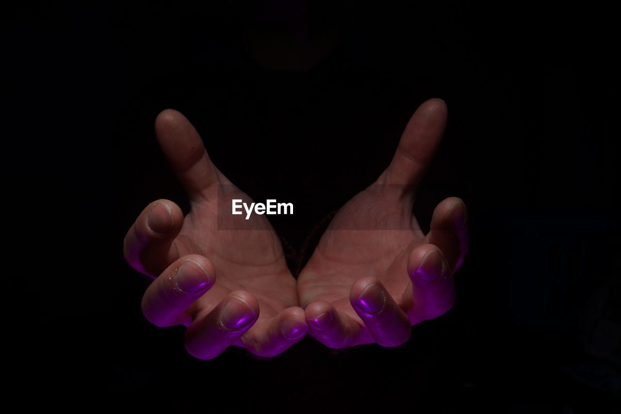 hand, finger, black background, studio shot, one person, close-up, indoors, darkness, purple, hand sign, gesturing, adult, petal