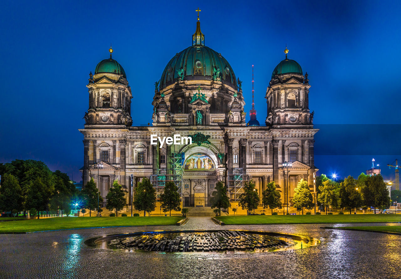 VIEW OF ILLUMINATED CATHEDRAL AGAINST BLUE SKY