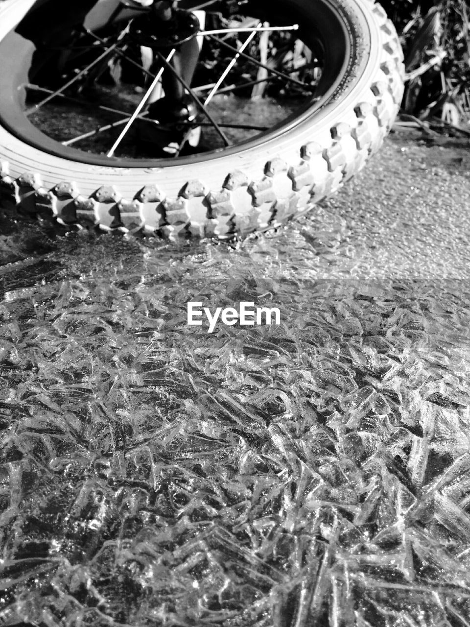 Cropped image of motorcycle on snowcapped field