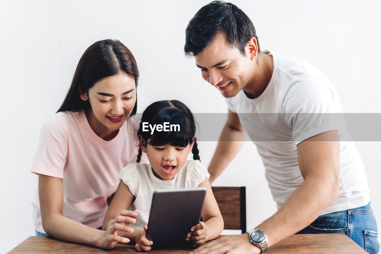 HAPPY MOTHER AND SON USING SMART PHONE AT HOME